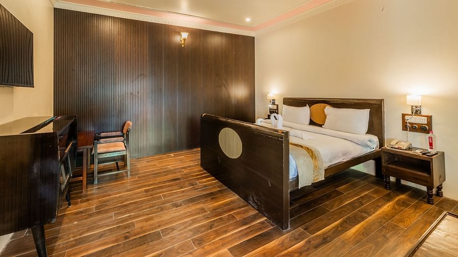 an image of a bedroom with a bed and lamps on each sides.